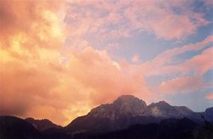 Firery clouds on pale blue sky above the Videmanette