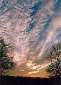 Sunset with diagonal stripes of cloud