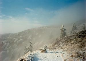 Bench on hiking path overlooking a valley