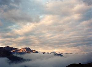 Setting sun in a cloudy sky above the Partnun Valley