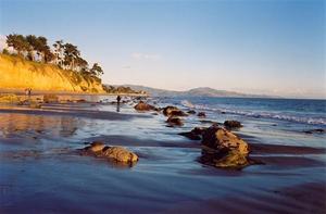 Yellow rocks and blue beach at sunset