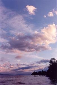 Pastel colour clouds over lake