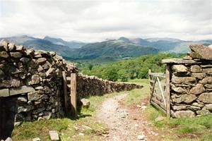 Stone walls with fence, with view over hillls