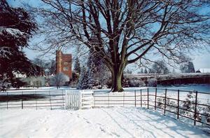 View of Tower from southern field with gate, snow