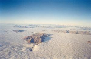 New Zealand mountain peaks above clouds, view from plane
