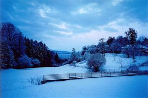 Blue snow covered hill over lake Constanz