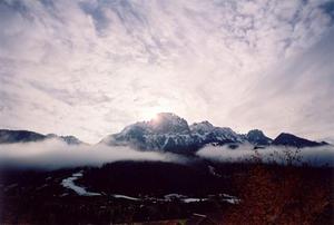 Sun behind clouds and Videmanette, mist clouds