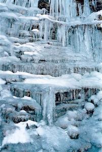 Blue ice formations on waterfall