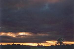 Orange sunset line above low set horizon, dark sky