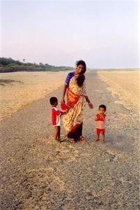 Mother with two kids on the beach