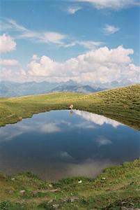 Mountain lake mirroring clouds