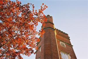 Brick red Brockwood Tower beside red autumn leaves